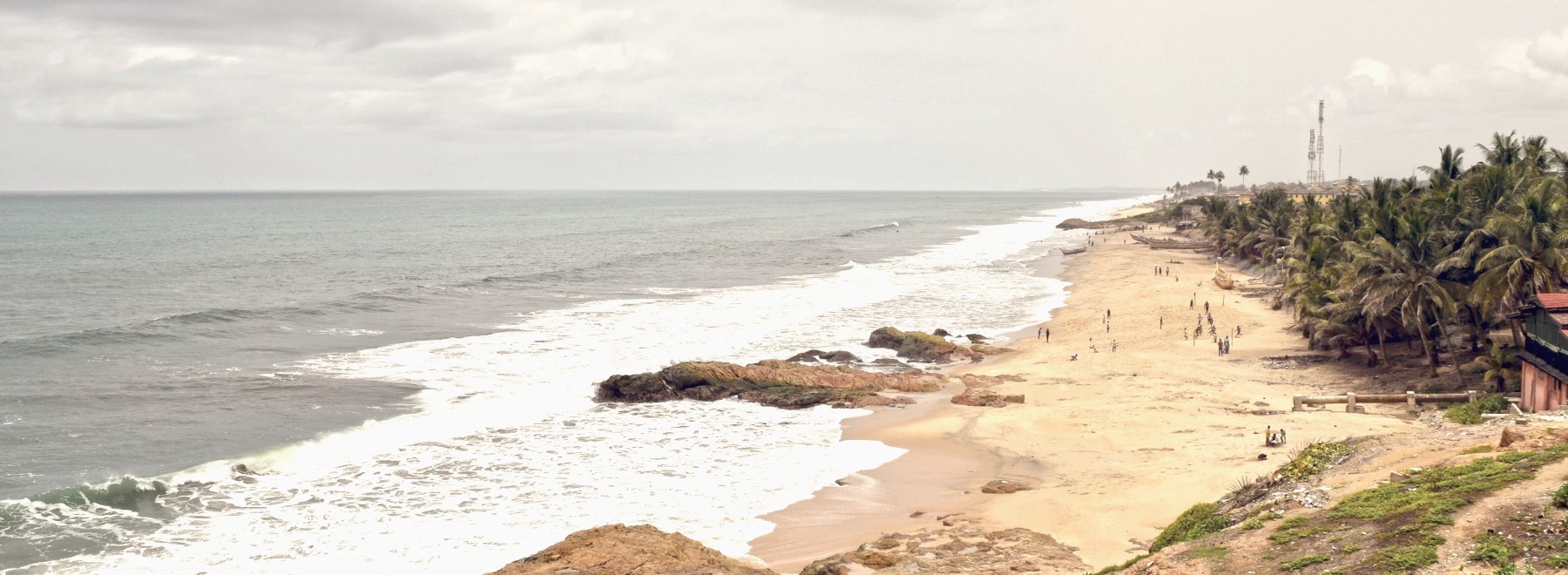 The Ghanaian coast seen from high ground, with palms along the shore