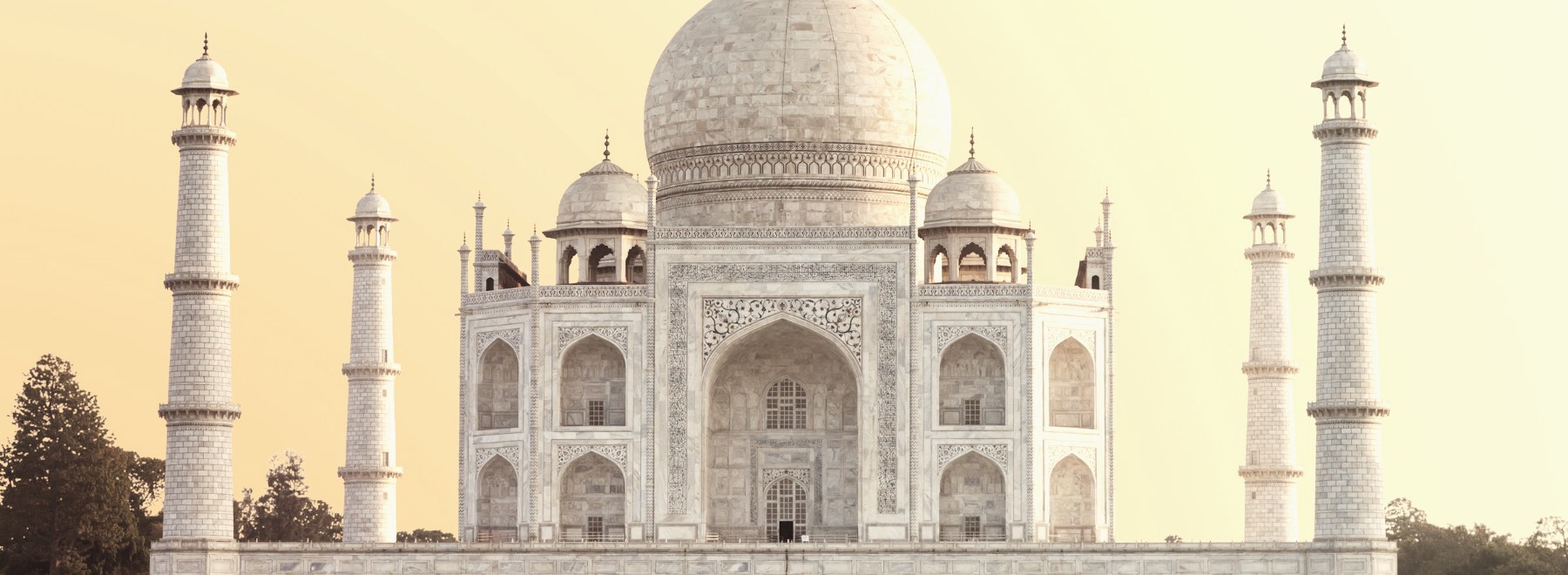 The Taj Mahal in Agra under a warm golden hour sky